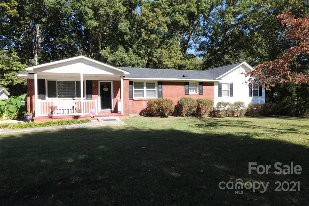 4797 River Road Stanfield, NC 28163 - Photo 1 of 4 a front view of a house with garden