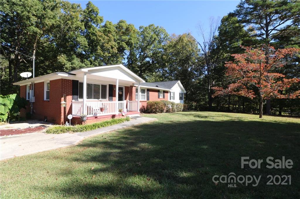 4797 River Road Stanfield, NC 28163 - Photo 2 of 4 a front view of a house with a garden