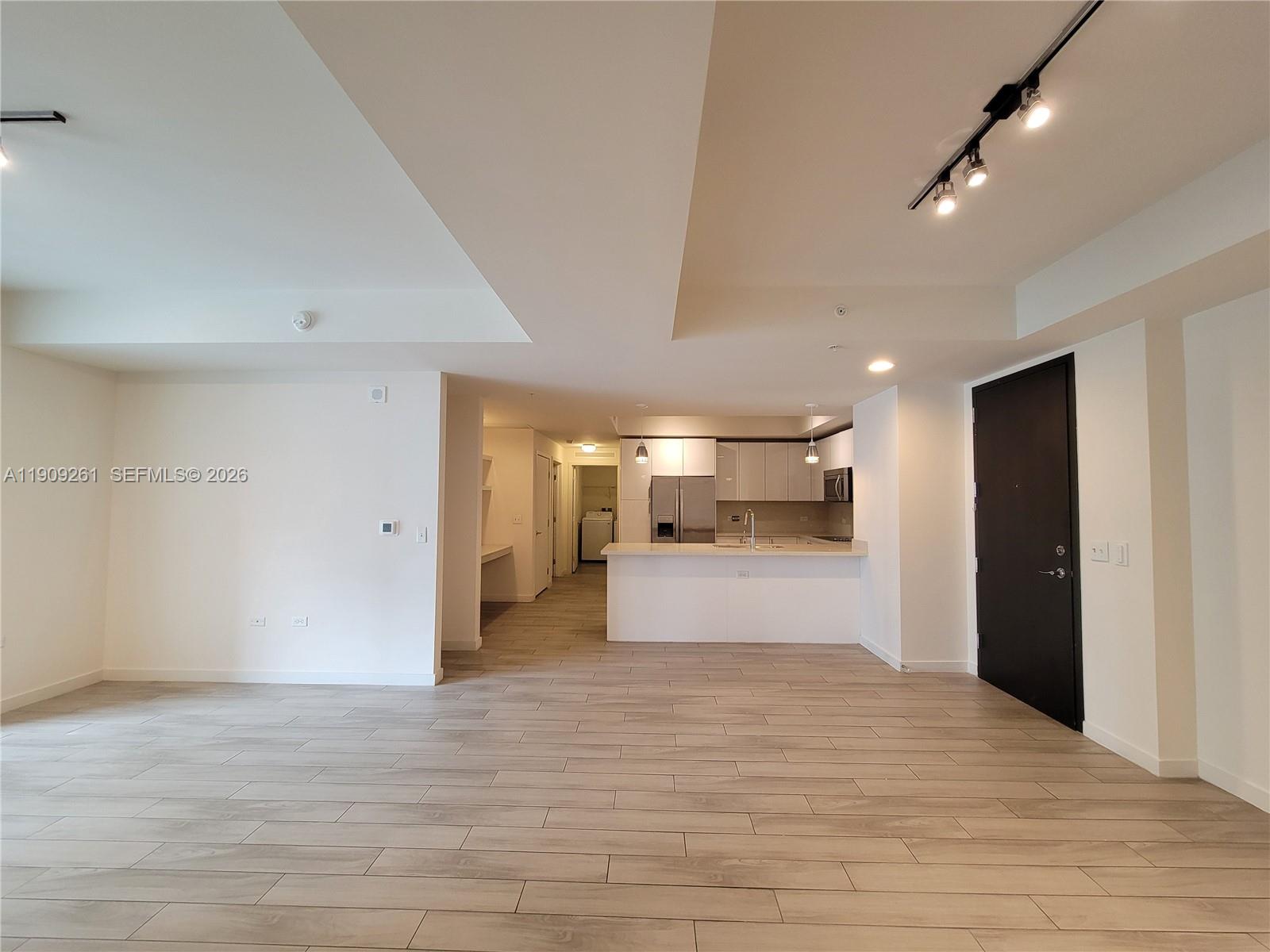 999 Southwest 1st Avenue, Unit 2016 Miami, FL 33130 - Photo 15 of 49 a room with a couch and a dresser in it