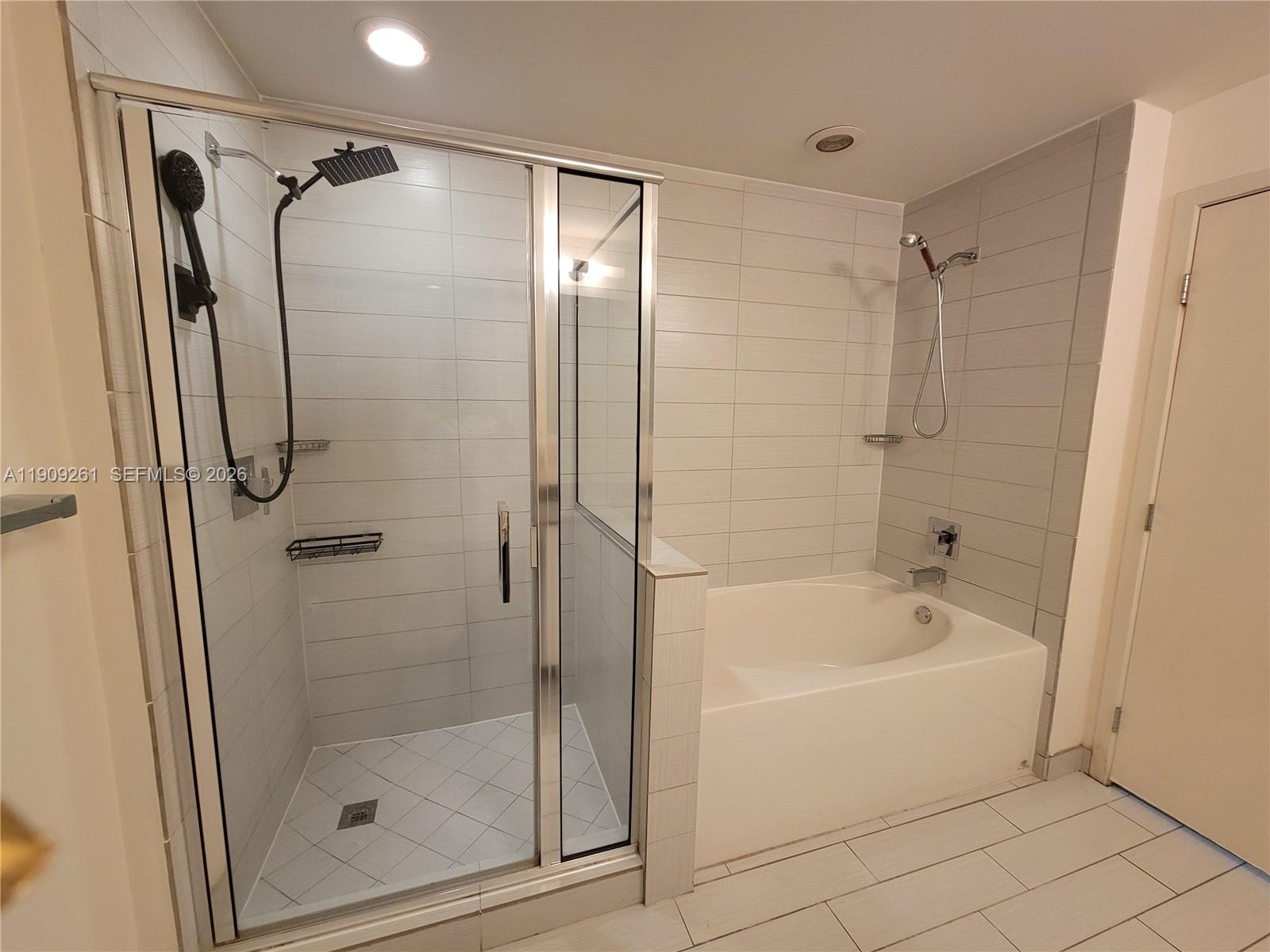999 Southwest 1st Avenue, Unit 2016 Miami, FL 33130 - Photo 31 of 49 a bathroom with a shower and a bath tub