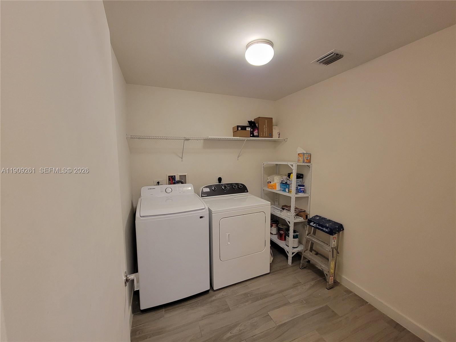 999 Southwest 1st Avenue, Unit 2016 Miami, FL 33130 - Photo 42 of 49 a utility room with dryer and washer