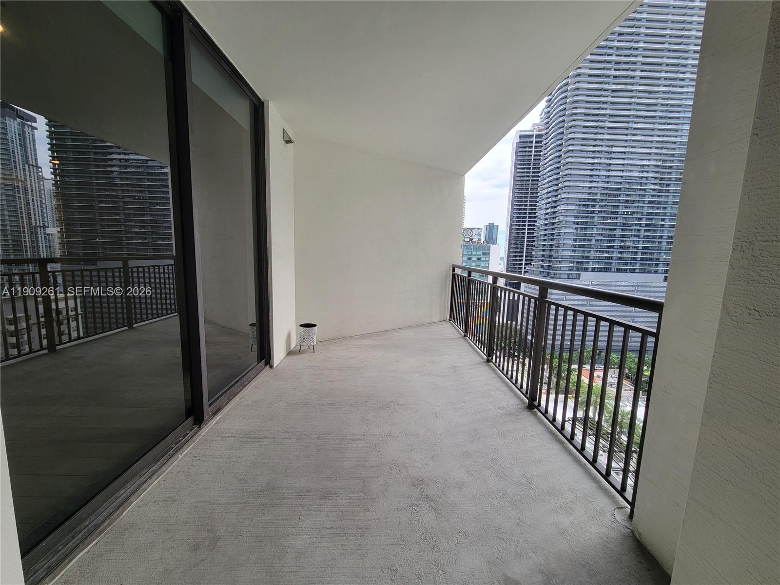 999 Southwest 1st Avenue, Unit 2016 Miami, FL 33130 - Photo 43 of 49 a view of a balcony with wooden floor