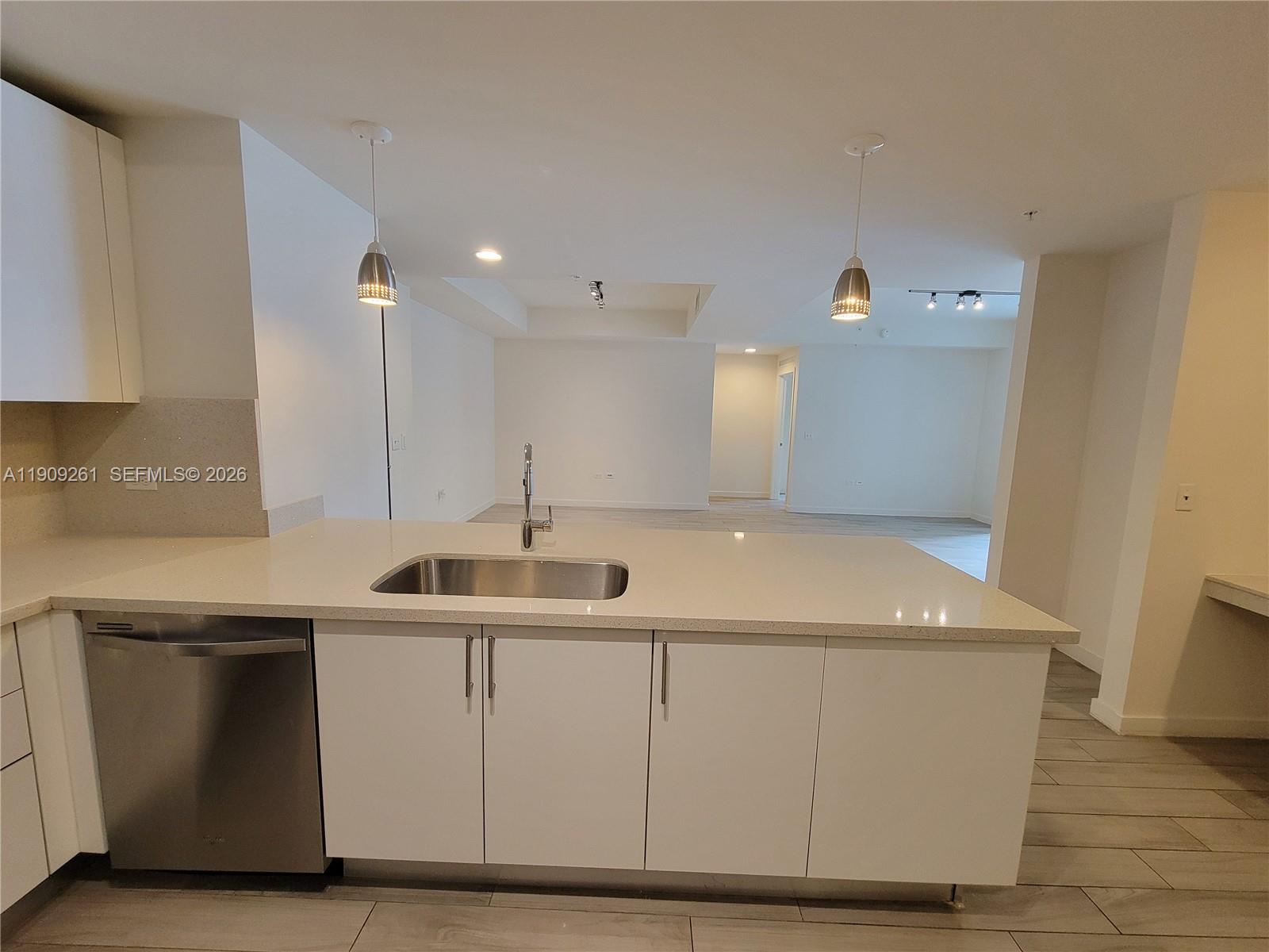 999 Southwest 1st Avenue, Unit 2016 Miami, FL 33130 - Photo 8 of 49 a kitchen with a sink and cabinets