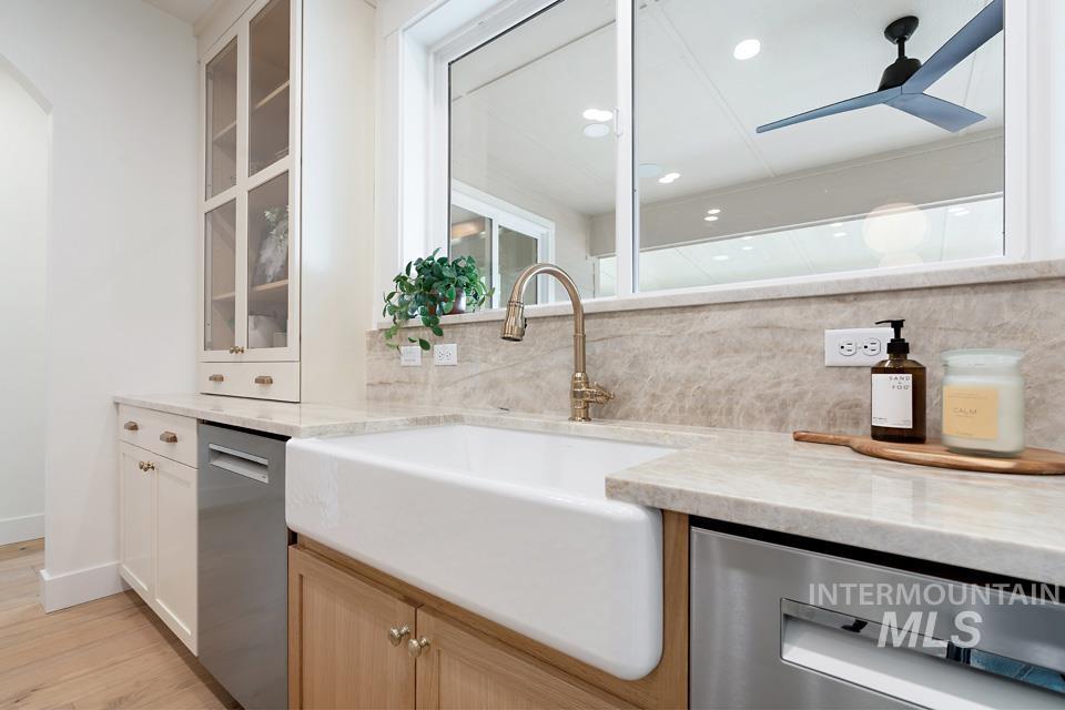 3322 South Volunteer Place Meridian, ID 83642 - Photo 17 of 50 Kitchen with tasteful backsplash, stainless steel dishwasher, light stone countertops, white cabinets, and recessed lighting