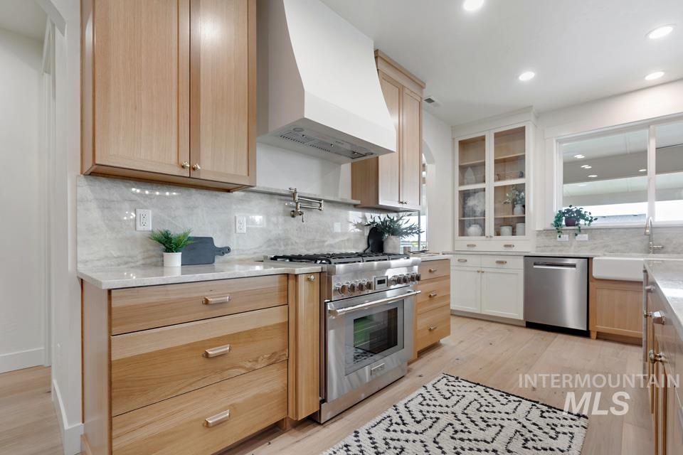 3322 South Volunteer Place Meridian, ID 83642 - Photo 24 of 50 Kitchen featuring premium range hood, light brown cabinetry, stainless steel appliances, tasteful backsplash, and recessed lighting
