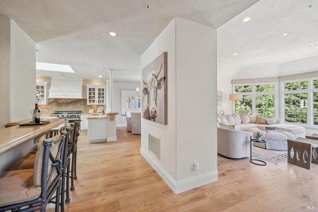 a living room with fireplace and a chandelier