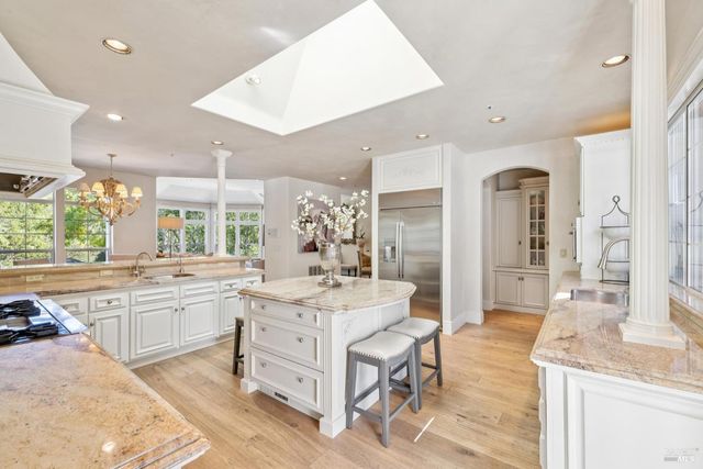 a bathroom with a sink vanity granite tub and shower