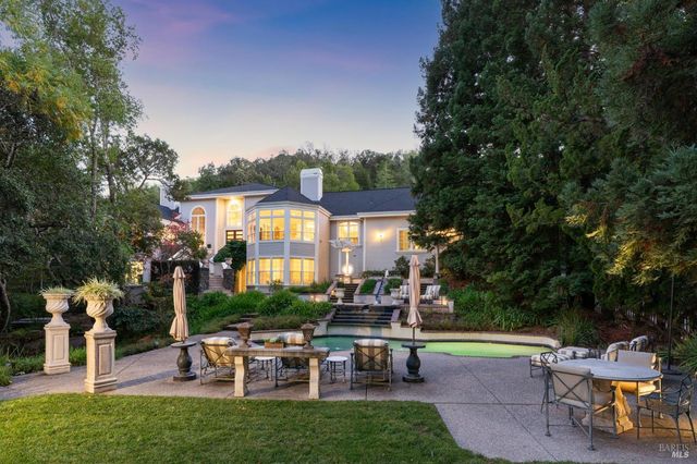 a view of a house with backyard sitting area and garden