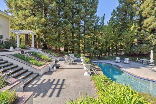 a aerial view of a house with swimming pool and garden