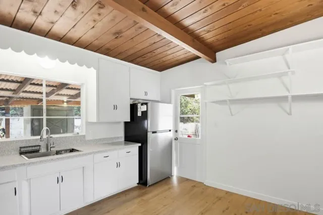 a kitchen with refrigerator and window