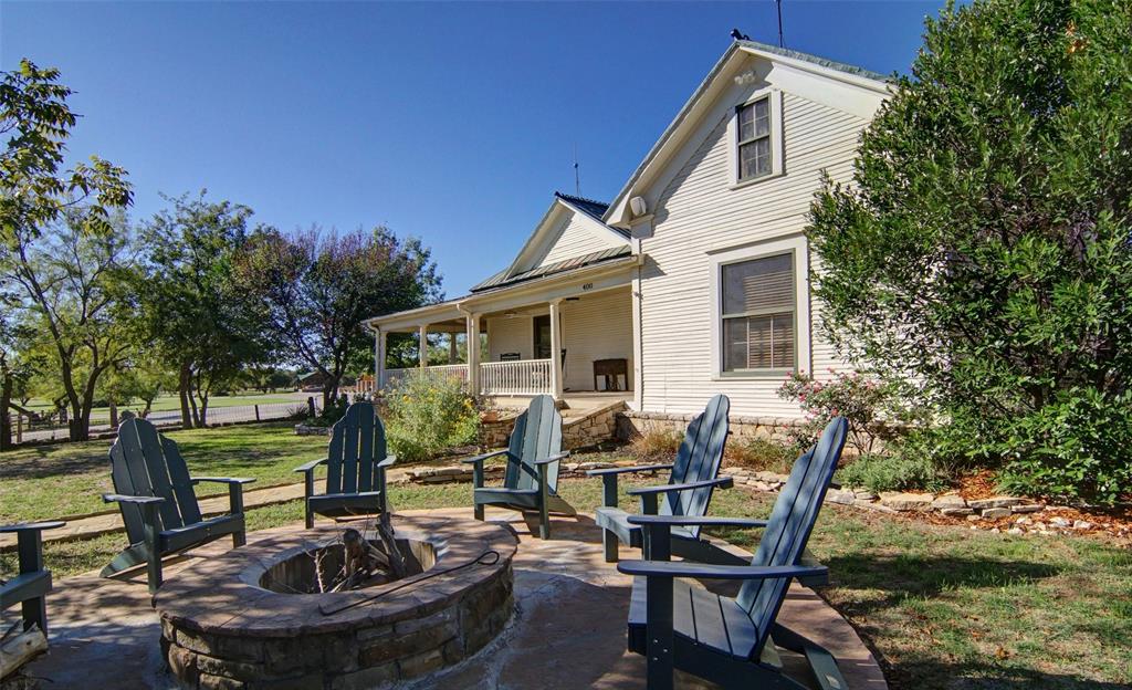 a view of a dinning table and chairs in patio of the house