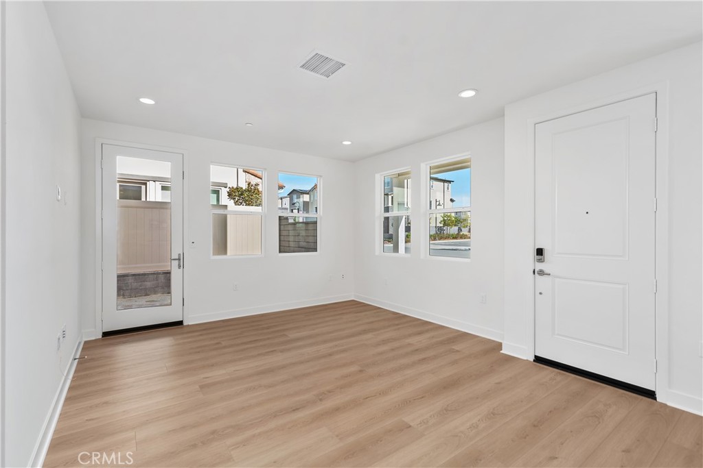 31645 Williams Rancho Mission Rancho Mission Viejo, CA 92694 - Photo 7 of 58 an empty room with wooden floor and windows
