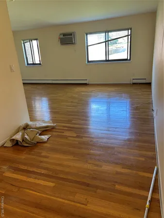 a room with wooden floor and window