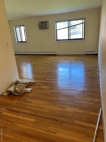 a room with wooden floor and window