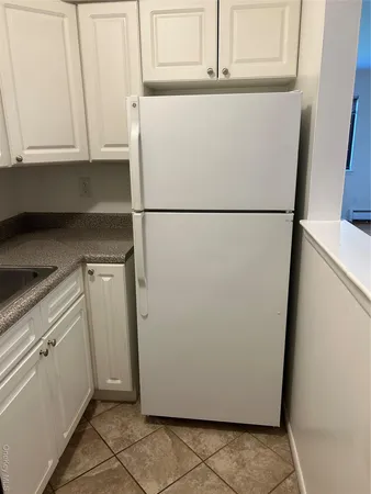 a white refrigerator freezer sitting in a kitchen