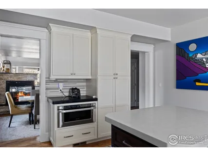 a kitchen with kitchen island granite countertop a sink a stove and cabinets