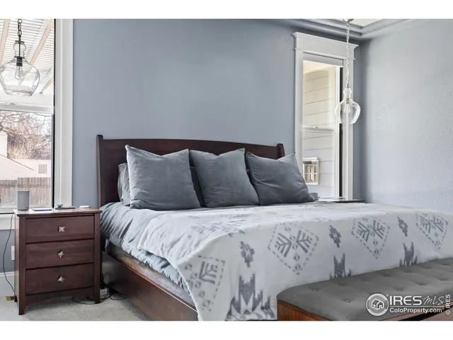 a bedroom with a bed and a large mirror