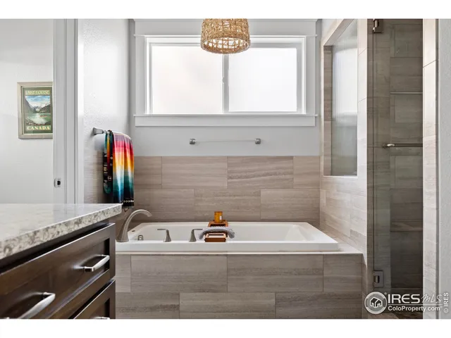 a en suite bathroom with a granite countertop tub and a shower