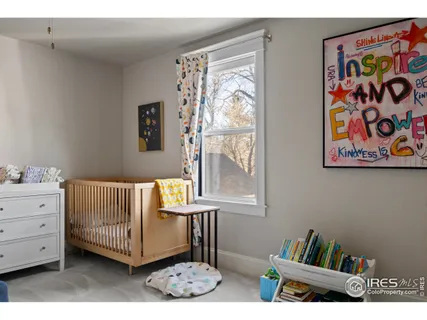 a living room with furniture and a wall painting