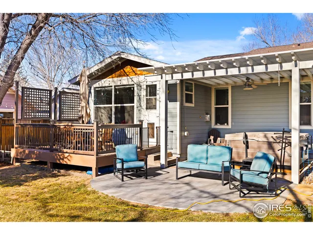 a view of a chairs and table in the back yard of the house