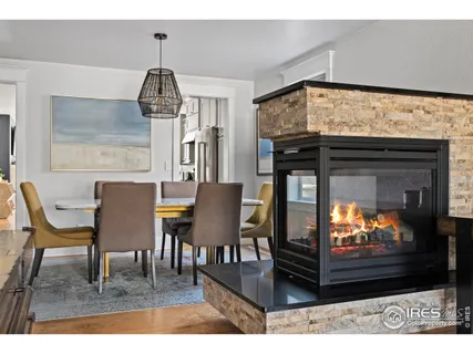 a dining room with furniture and wooden floor