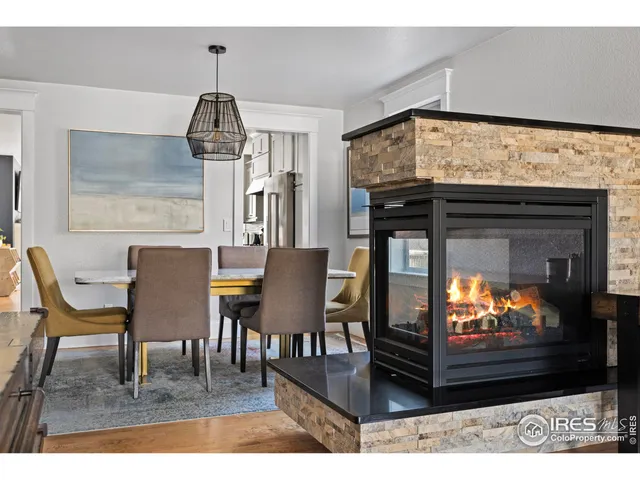 a dining room with furniture and wooden floor