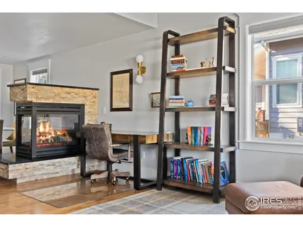 a living room with lots of furniture and a book shelf