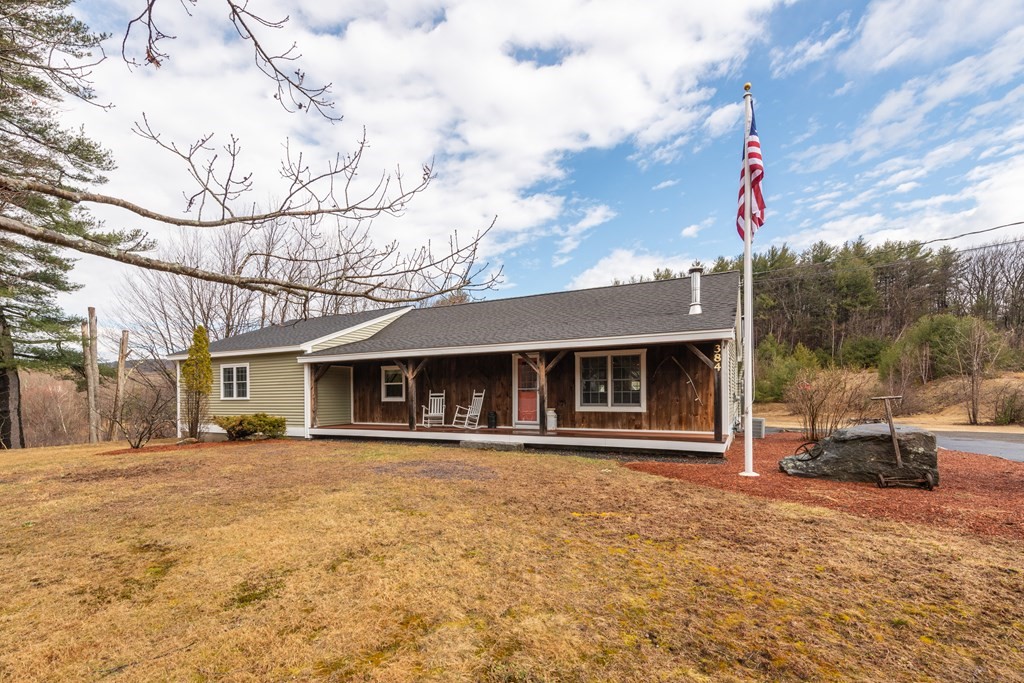 384 Richardson Road Ashby, MA 01431 - Photo 1 of 40 a front view of a house with basket ball court and outdoor seating