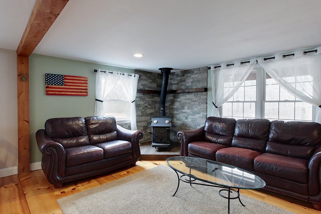 384 Richardson Road Ashby, MA 01431 - Photo 11 of 40 a living room with furniture and a fireplace