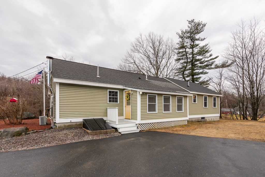384 Richardson Road Ashby, MA 01431 - Photo 2 of 40 a front view of a house with a yard