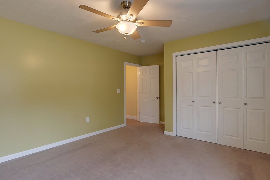 384 Richardson Road Ashby, MA 01431 - Photo 21 of 40 an empty room with a ceiling fan and a fan