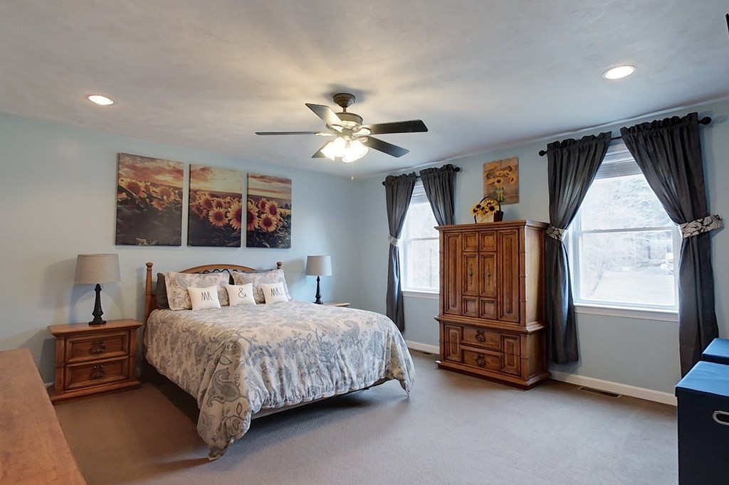 384 Richardson Road Ashby, MA 01431 - Photo 22 of 40 a bedroom with a bed and a chandelier