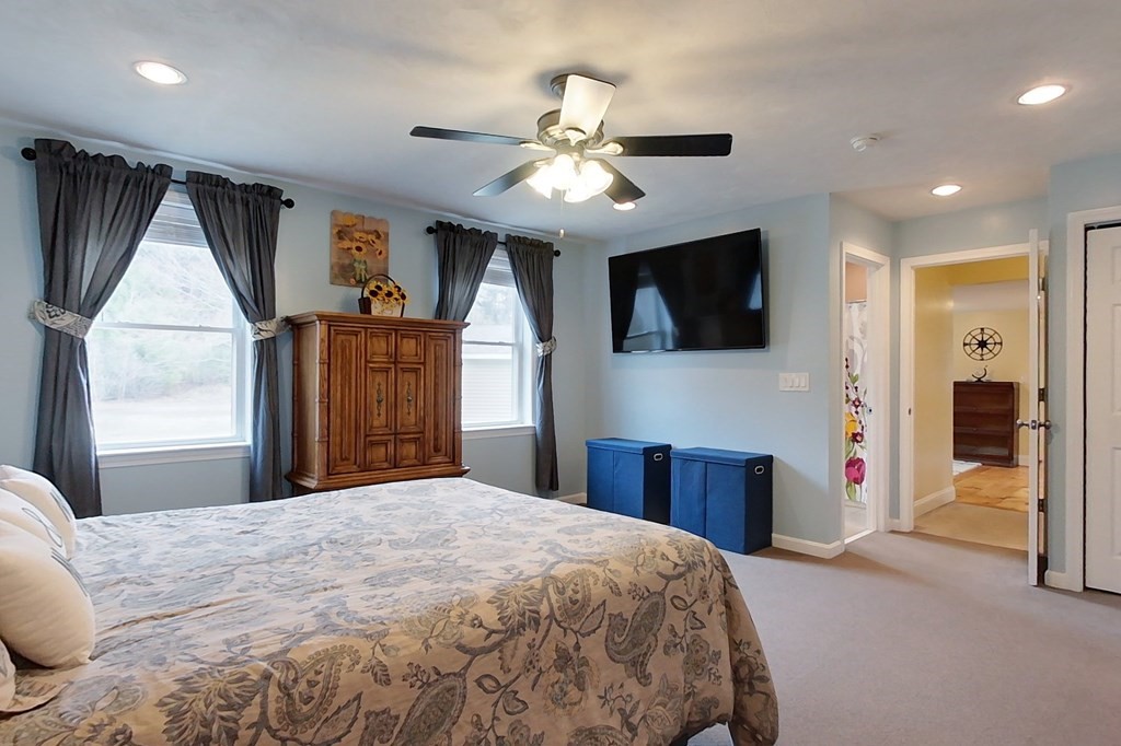 384 Richardson Road Ashby, MA 01431 - Photo 23 of 40 a bedroom with a large bed and a flat tv screen