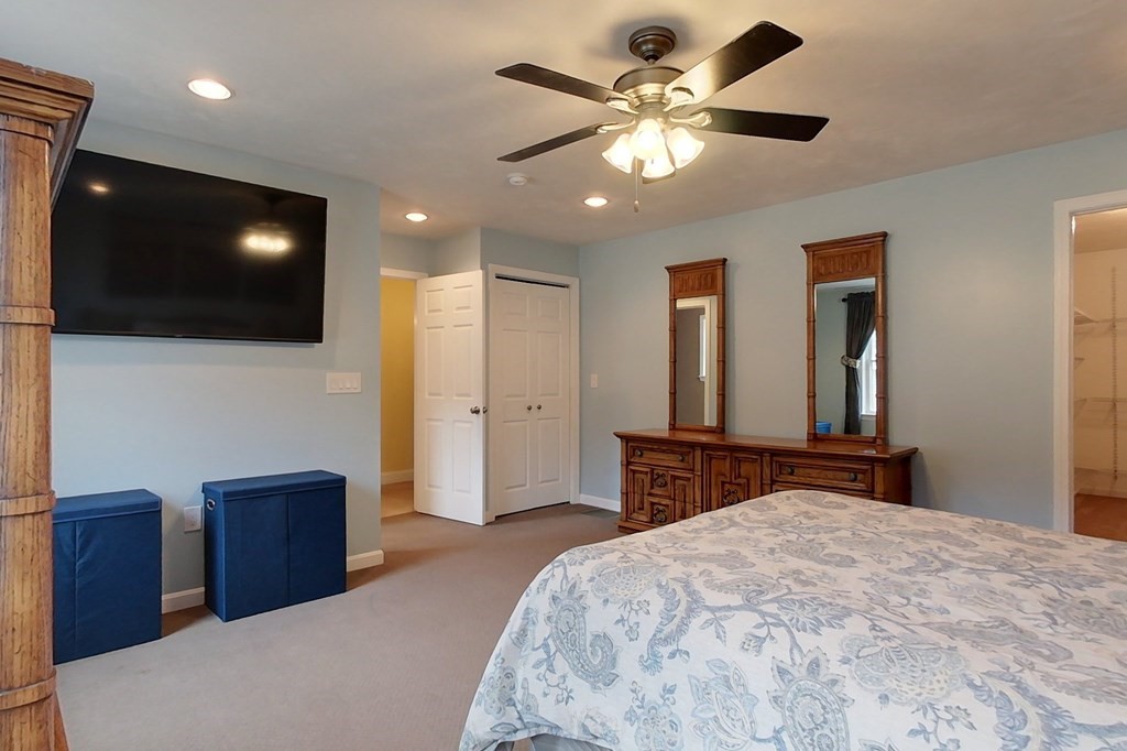 384 Richardson Road Ashby, MA 01431 - Photo 24 of 40 a bedroom with a large bed and a flat screen tv