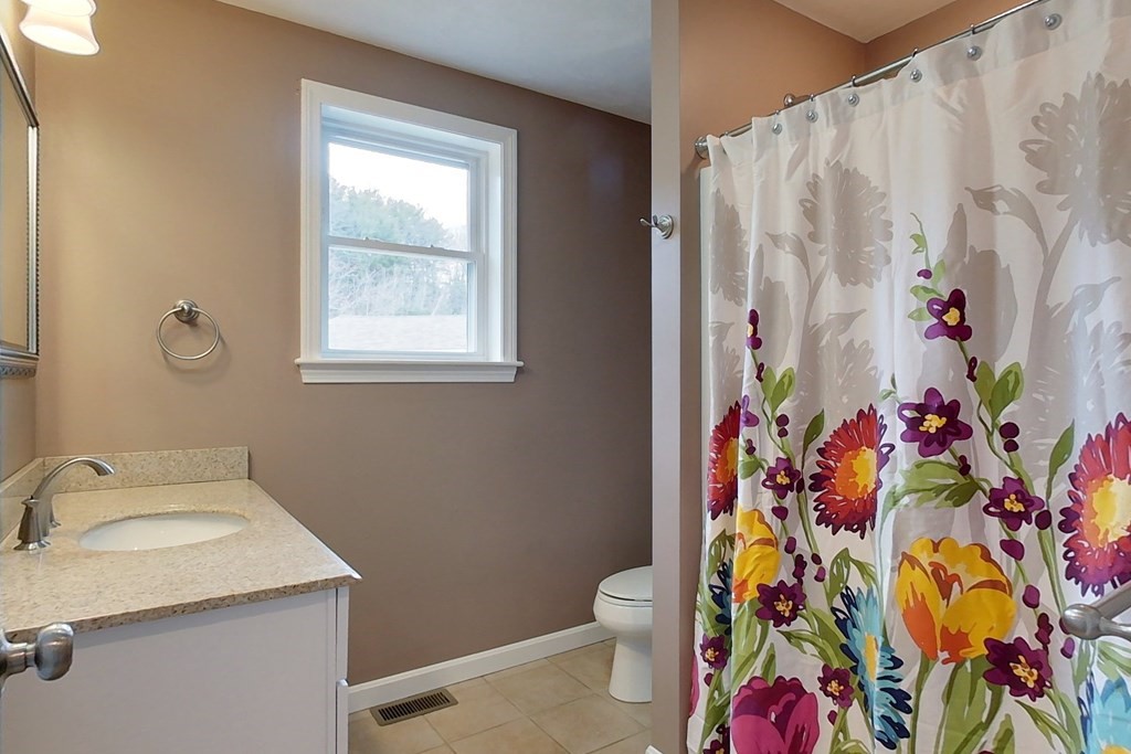 384 Richardson Road Ashby, MA 01431 - Photo 27 of 40 a bathroom with a sink and a curtain
