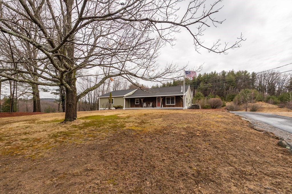 384 Richardson Road Ashby, MA 01431 - Photo 37 of 40 a view of a house with a yard covered in snow