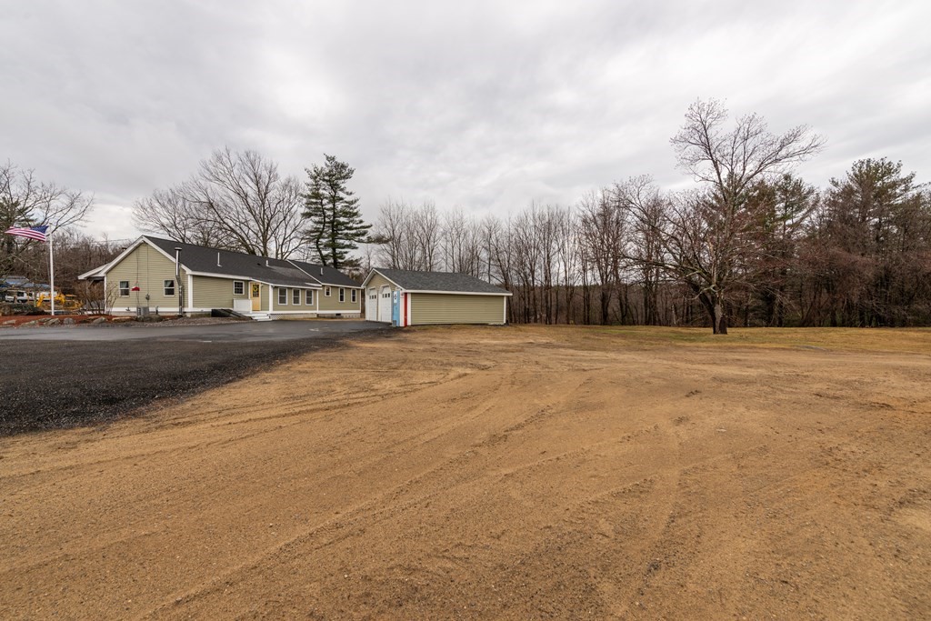 384 Richardson Road Ashby, MA 01431 - Photo 38 of 40 a view of swimming pool with outdoor seating and house in the background