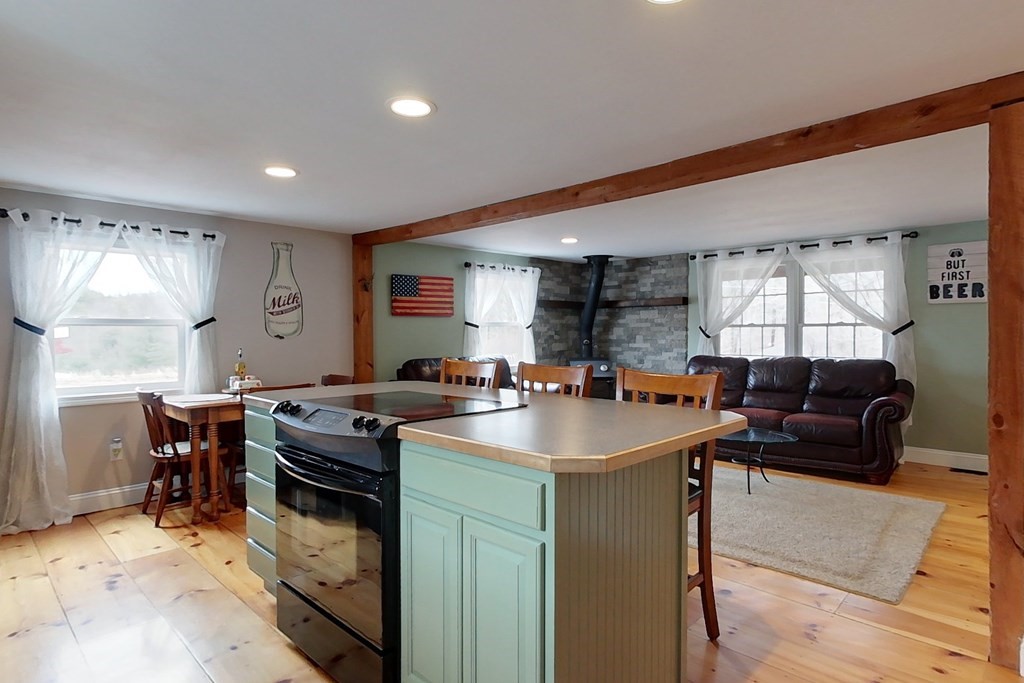 384 Richardson Road Ashby, MA 01431 - Photo 4 of 40 a kitchen with stainless steel appliances granite countertop a sink a stove and a refrigerator