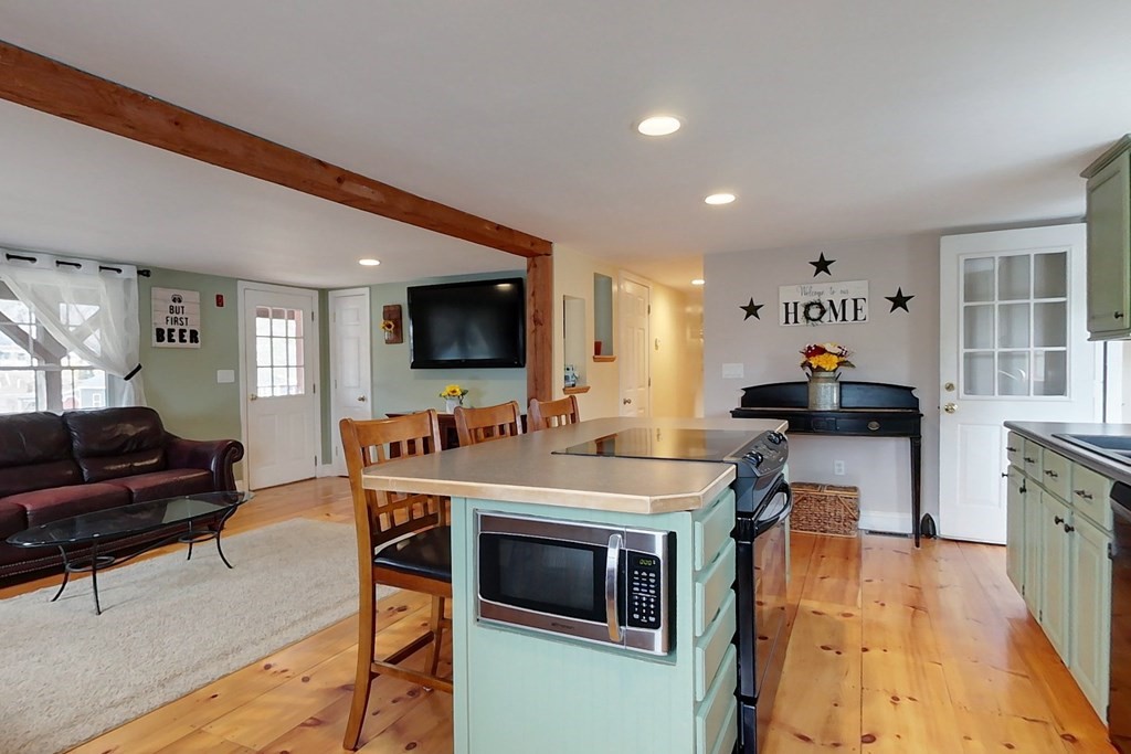 384 Richardson Road Ashby, MA 01431 - Photo 5 of 40 a living room with furniture and a flat screen tv