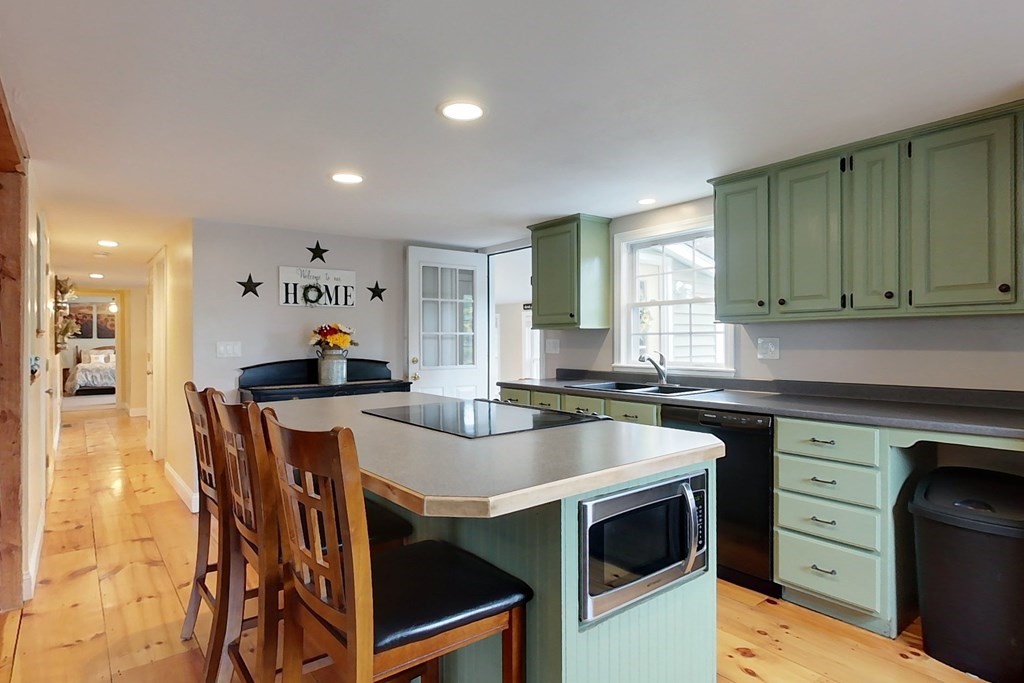 384 Richardson Road Ashby, MA 01431 - Photo 6 of 40 a kitchen with stainless steel appliances a stove a sink cabinets and a refrigerator