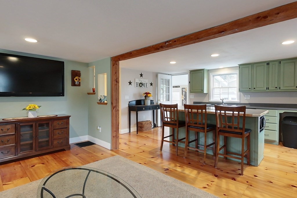 384 Richardson Road Ashby, MA 01431 - Photo 9 of 40 a living room with furniture and a flat screen tv
