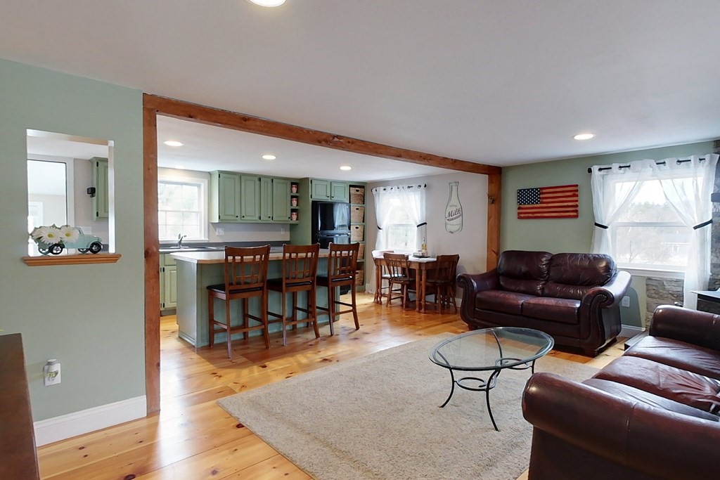 384 Richardson Road Ashby, MA 01431 - Photo 10 of 40 a living room with furniture and a wooden floor