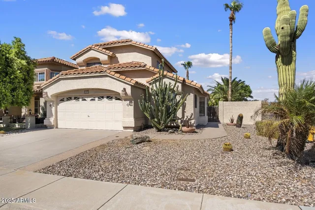 a view of a house with a yard and garage