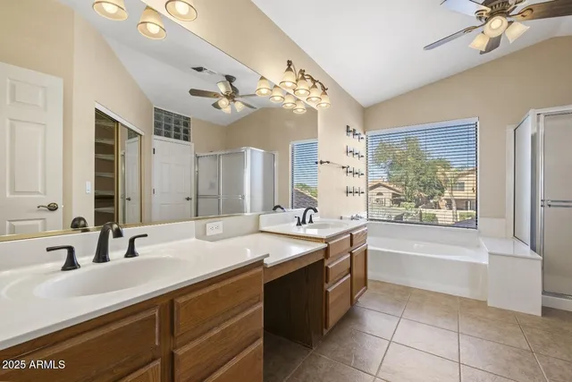 a spacious bathroom with a tub sink and mirror