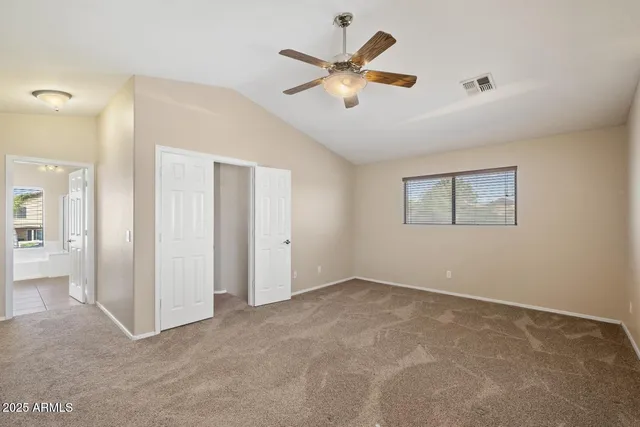 a view of an empty room with a ceiling fan