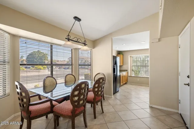 a dining room with furniture and window