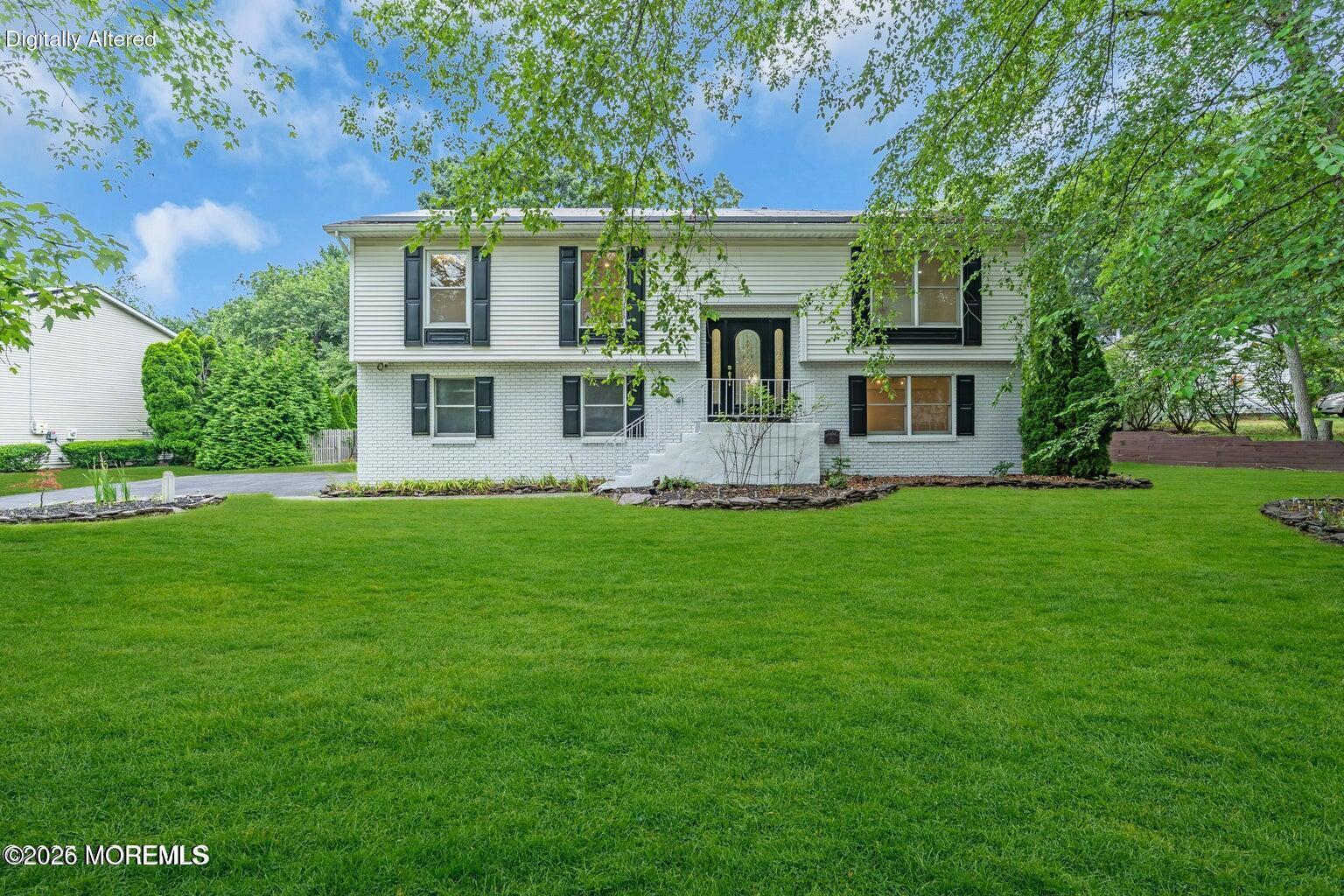 a front view of a house with a garden