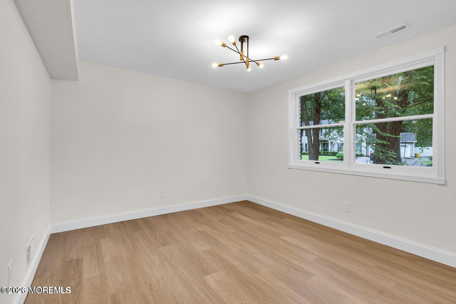 88 Hickory Hill Road Jackson, NJ 08527 - Photo 13 of 21 wooden floor in an empty room with a window