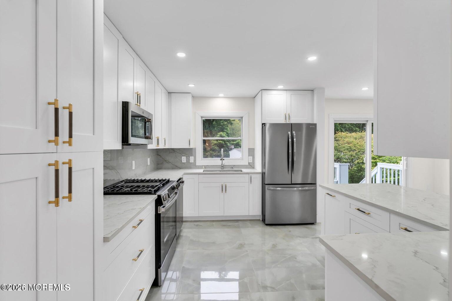 88 Hickory Hill Road Jackson, NJ 08527 - Photo 14 of 21 a kitchen with a refrigerator and a stove top oven
