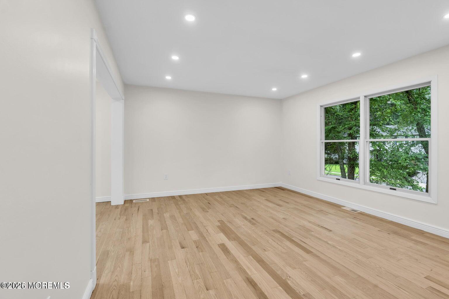88 Hickory Hill Road Jackson, NJ 08527 - Photo 20 of 21 an empty room with wooden floor and windows